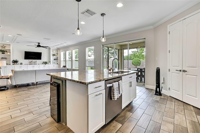 1669 Feather Grass Loop, Lutz, FL 33558 - kitchen with stainless steel dishwasher, beverage cooler, crown molding, stone countertops, and white cabinetry