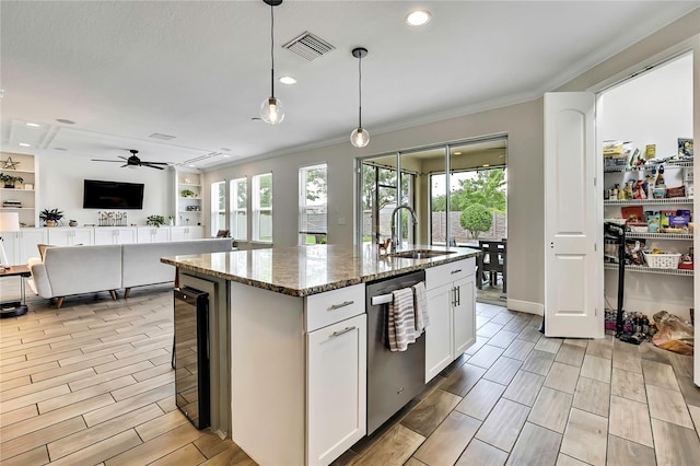 1669 Feather Grass Loop, Lutz, FL 33558 - kitchen featuring stainless steel dishwasher, beverage cooler, ornamental molding, stone countertops, and white cabinets