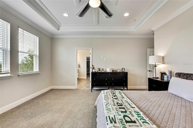 1669 Feather Grass Loop, Lutz, FL 33558 - bedroom featuring a tray ceiling, crown molding, carpet, a ceiling fan, and connected bathroom