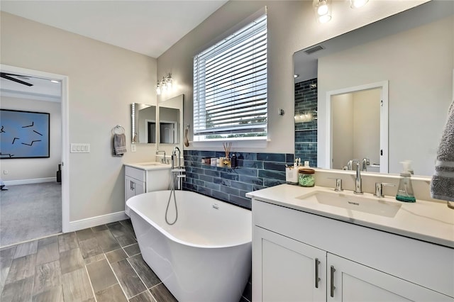 1669 Feather Grass Loop, Lutz, FL 33558 - bathroom with a freestanding bath, vanity, decorative backsplash, and tiled shower