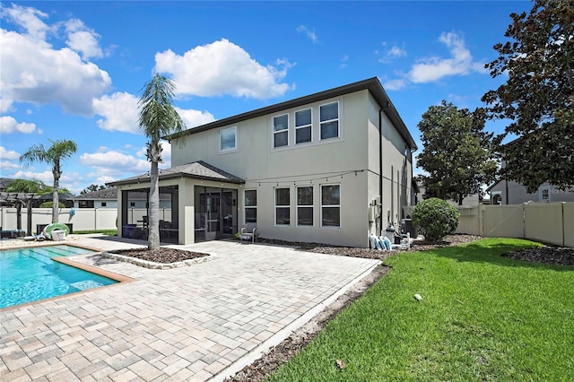 1669 Feather Grass Loop, Lutz, FL 33558 - back of house with a sunroom, stucco siding, a patio area, and a fenced backyard