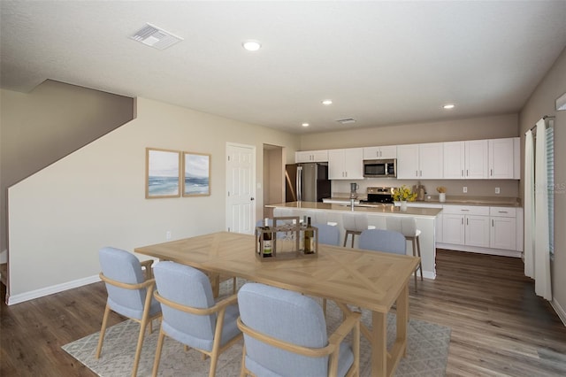 1229 Tidal St, Haines City, FL 33844 - dining area featuring dark wood finished floors and recessed lighting