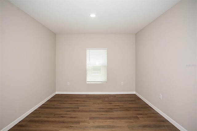 1229 Tidal St, Haines City, FL 33844 - empty room featuring dark wood-type flooring and recessed lighting