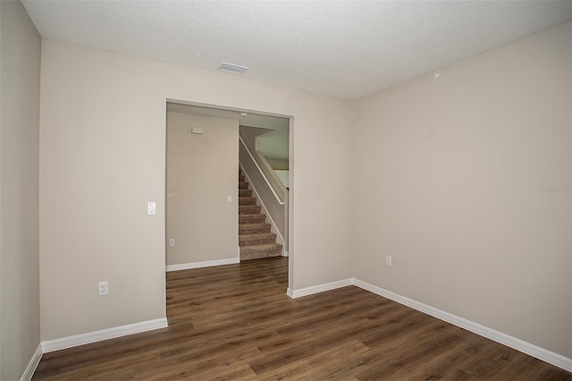 1229 Tidal St, Haines City, FL 33844 - spare room featuring wood finished floors and stairway