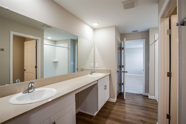 1229 Tidal St, Haines City, FL 33844 - full bathroom featuring double vanity, wood finished floors, and a shower