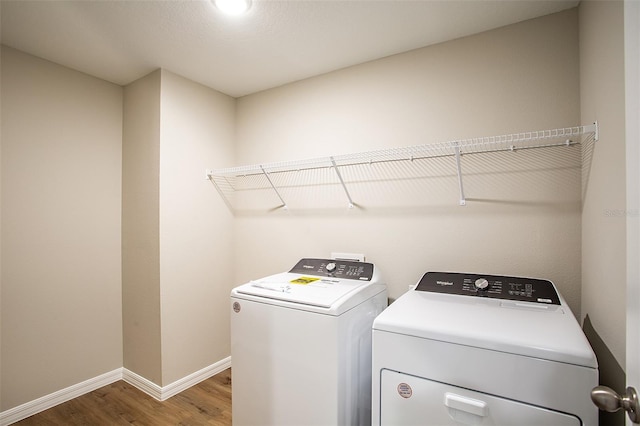 1229 Tidal St, Haines City, FL 33844 - washroom with washing machine and dryer and wood finished floors