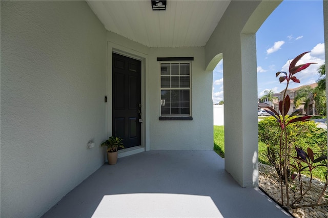 9110 Lantern Oak Way, Land O Lakes, FL 34638 - doorway to property featuring stucco siding and a patio