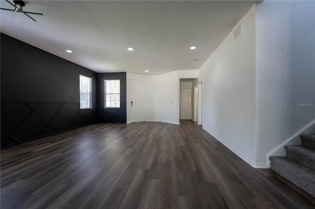 9110 Lantern Oak Way, Land O Lakes, FL 34638 - unfurnished living room with dark wood-style floors, recessed lighting, and stairs
