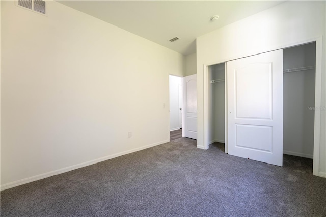 9110 Lantern Oak Way, Land O Lakes, FL 34638 - unfurnished bedroom featuring dark carpet and a closet