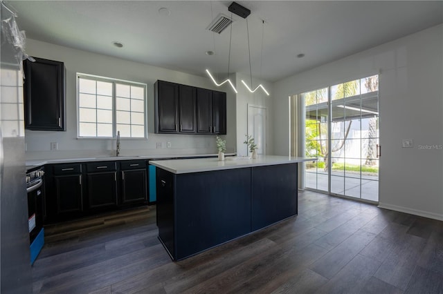 9110 Lantern Oak Way, Land O Lakes, FL 34638 - kitchen with healthy amount of natural light, light countertops, dark wood-style floors, a center island with sink, and recessed lighting