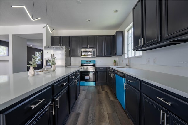 9110 Lantern Oak Way, Land O Lakes, FL 34638 - kitchen with appliances with stainless steel finishes, healthy amount of natural light, dark wood-type flooring, light countertops, and recessed lighting