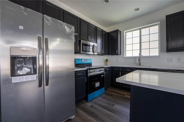 9110 Lantern Oak Way, Land O Lakes, FL 34638 - kitchen featuring stainless steel appliances, dark cabinets, dark wood-style floors, light countertops, and recessed lighting