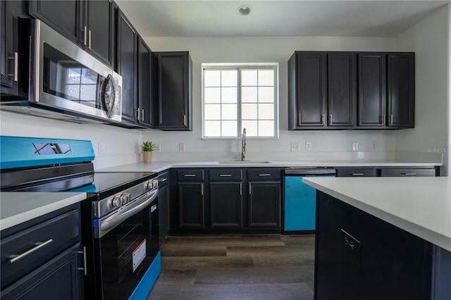 9110 Lantern Oak Way, Land O Lakes, FL 34638 - kitchen with appliances with stainless steel finishes, dark wood finished floors, light countertops, dark cabinetry, and recessed lighting