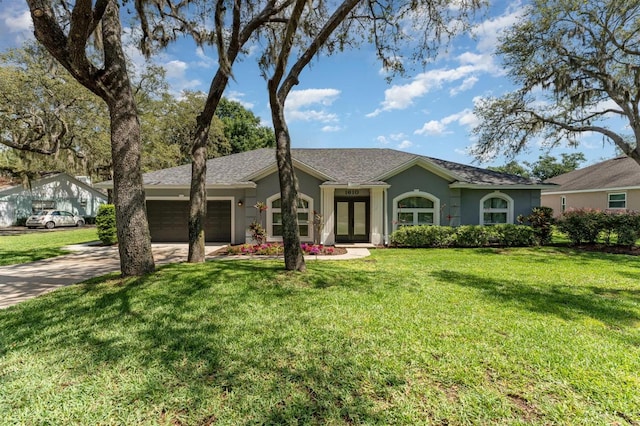 1610 Sherwood Lakes Blvd, Lakeland, FL 33809 - ranch-style home featuring a garage, french doors, concrete driveway, stucco siding, and a front lawn
