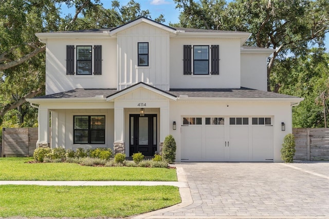 4114 W Neptune St, Tampa, FL 33629 - view of front of house featuring board and batten siding, an attached garage, decorative driveway, and roof with shingles