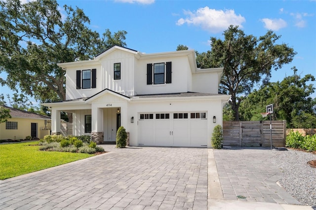 4114 W Neptune St, Tampa, FL 33629 - modern farmhouse with board and batten siding, decorative driveway, an attached garage, and stone siding