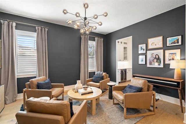 4114 W Neptune St, Tampa, FL 33629 - living area with light wood-style flooring, beverage cooler, and a chandelier