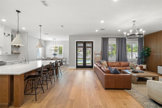 4114 W Neptune St, Tampa, FL 33629 - living room featuring a chandelier, light wood-style floors, recessed lighting, and french doors