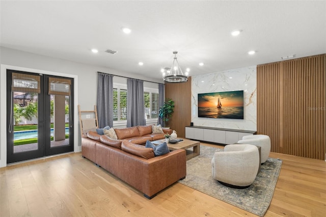 4114 W Neptune St, Tampa, FL 33629 - living room featuring a chandelier, recessed lighting, light wood-style flooring, and french doors