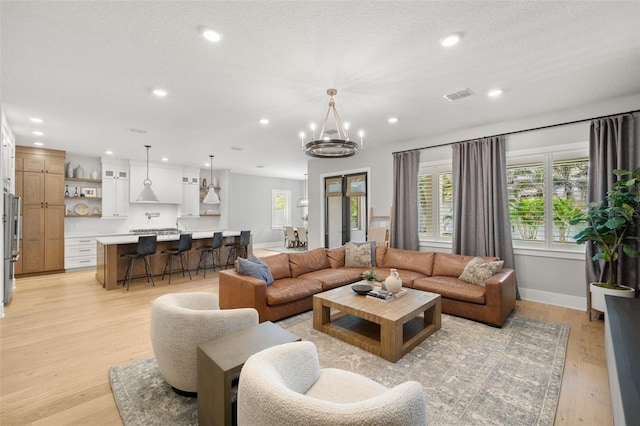 4114 W Neptune St, Tampa, FL 33629 - living room featuring recessed lighting, light wood-style floors, and a chandelier