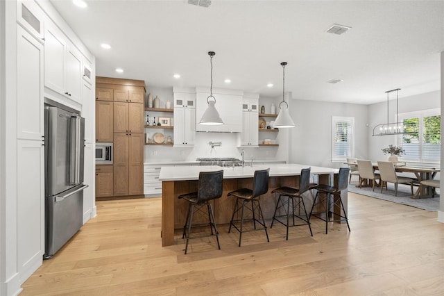 4114 W Neptune St, Tampa, FL 33629 - kitchen featuring appliances with stainless steel finishes, open shelves, light wood-type flooring, light countertops, and recessed lighting