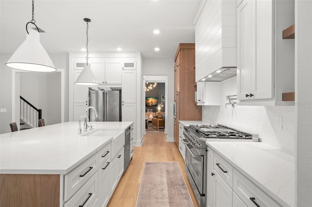 4114 W Neptune St, Tampa, FL 33629 - kitchen with appliances with stainless steel finishes, light wood finished floors, white cabinets, backsplash, and recessed lighting