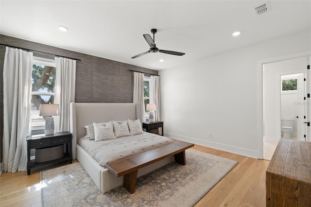 4114 W Neptune St, Tampa, FL 33629 - bedroom with light wood-style flooring, recessed lighting, an accent wall, wallpapered walls, and ceiling fan
