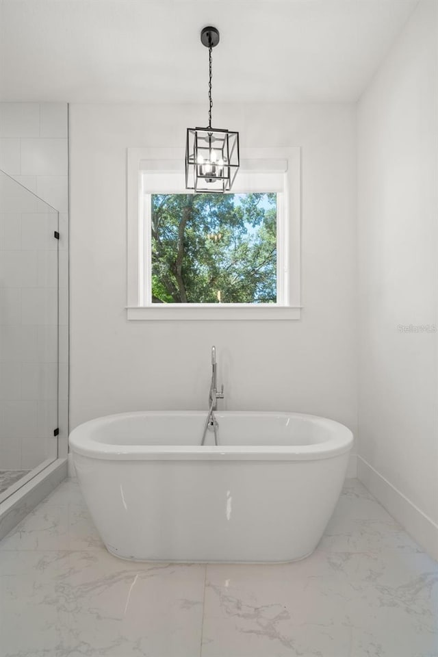 4114 W Neptune St, Tampa, FL 33629 - bathroom with marble finish floors, a chandelier, a freestanding tub, and a shower stall