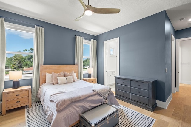 4114 W Neptune St, Tampa, FL 33629 - bedroom featuring light wood-type flooring, ensuite bath, ceiling fan, and a textured ceiling