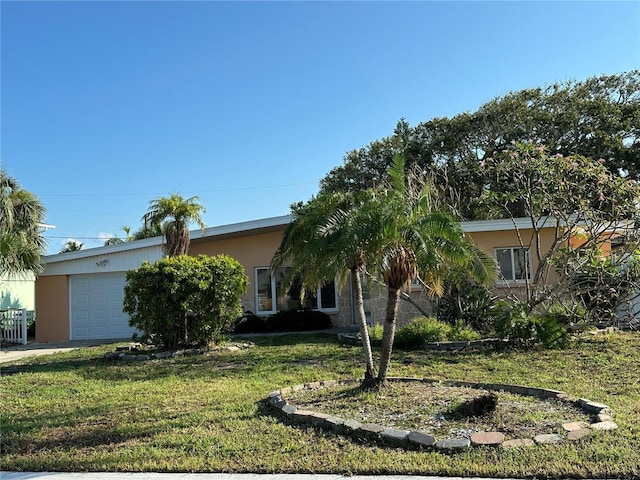 103 9th St, Belleair Beach, FL 33786 - obstructed view of property with a garage, stucco siding, and a front lawn