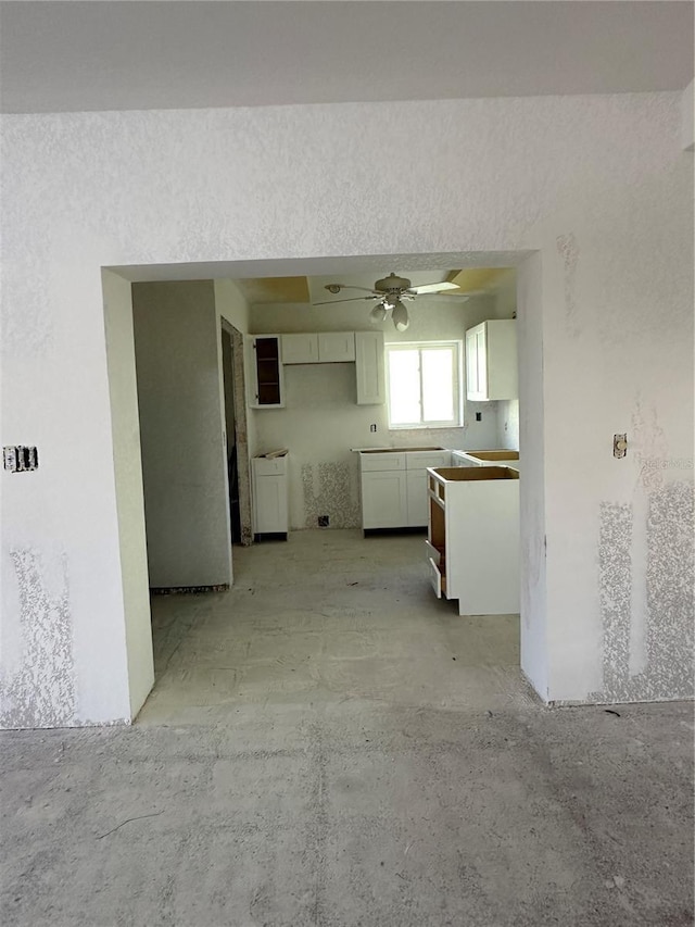 103 9th St, Belleair Beach, FL 33786 - kitchen featuring white cabinets and ceiling fan