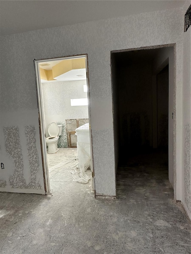 103 9th St, Belleair Beach, FL 33786 - hallway featuring a textured wall and carpet