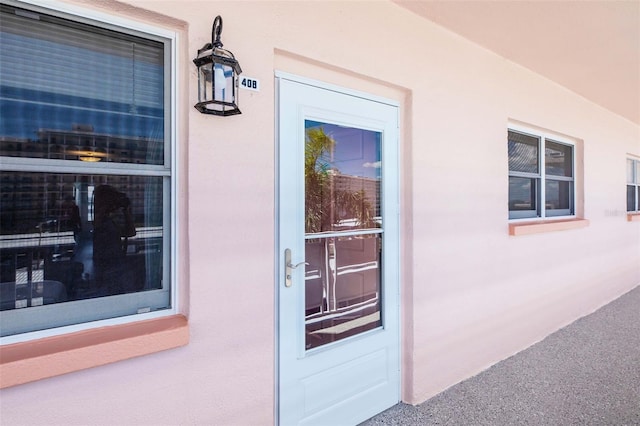 6025 Shore Blvd S Unit 408, Gulfport, FL 33707 - doorway to property with stucco siding
