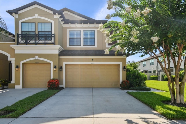 11519 Crowned Sparrow Ln, Tampa, FL 33626 - view of front of property with stucco siding, a garage, driveway, and a balcony