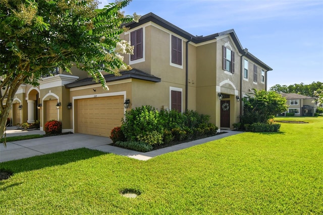 11519 Crowned Sparrow Ln, Tampa, FL 33626 - townhome / multi-family property with stucco siding, driveway, a front lawn, and a garage