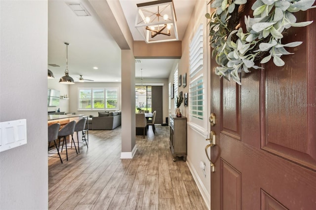 11519 Crowned Sparrow Ln, Tampa, FL 33626 - foyer with light wood finished floors, a chandelier, and recessed lighting