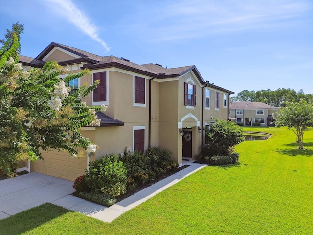11519 Crowned Sparrow Ln, Tampa, FL 33626 - townhome / multi-family property featuring stucco siding, concrete driveway, a front yard, and a garage