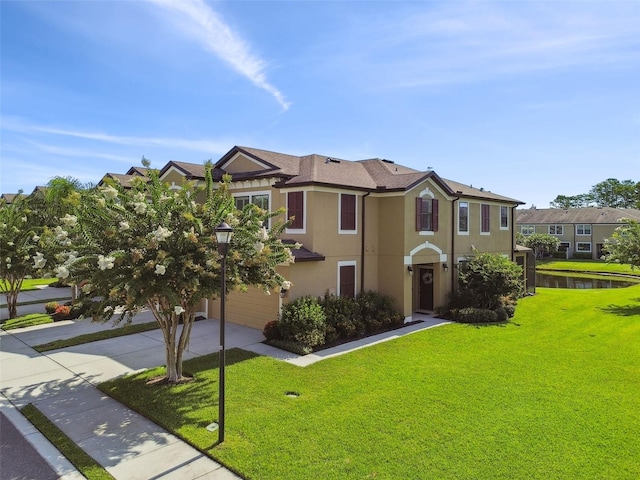 11519 Crowned Sparrow Ln, Tampa, FL 33626 - view of front of house featuring driveway, a garage, stucco siding, a front yard, and a water view