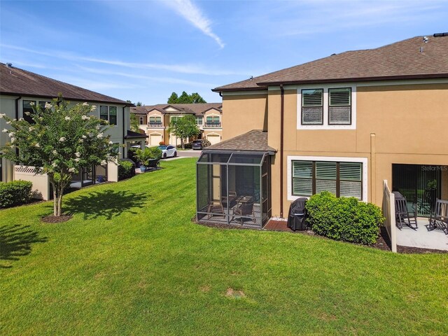 11519 Crowned Sparrow Ln, Tampa, FL 33626 - view of grassy yard featuring a sunroom, a patio area, and a residential view