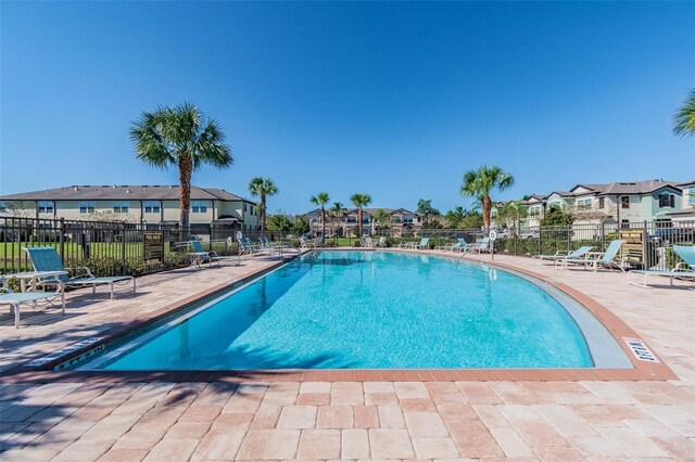 11519 Crowned Sparrow Ln, Tampa, FL 33626 - community pool featuring a residential view and a patio area