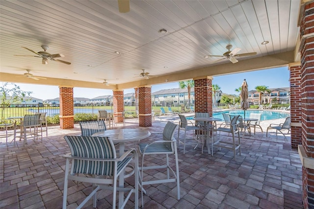 11519 Crowned Sparrow Ln, Tampa, FL 33626 - view of patio featuring ceiling fan and a community pool