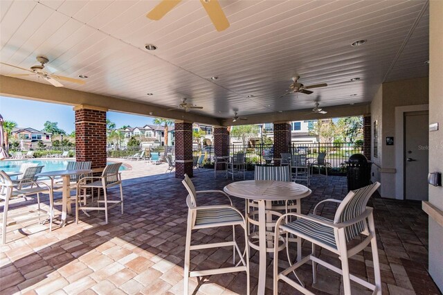 11519 Crowned Sparrow Ln, Tampa, FL 33626 - view of patio featuring ceiling fan, a community pool, and outdoor dining area