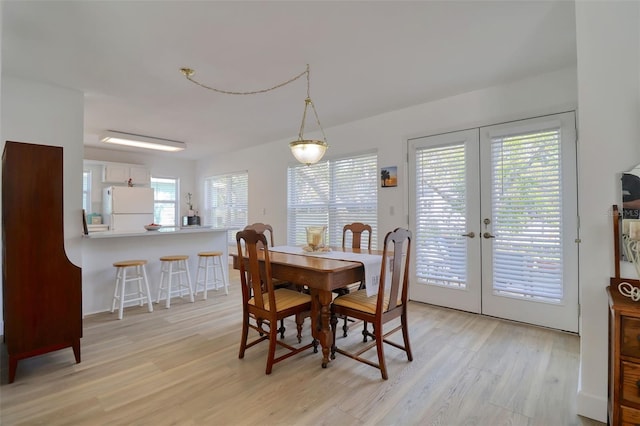408 Georgia Ave, Crystal Beach, FL 34681 - dining space with french doors and light wood-type flooring