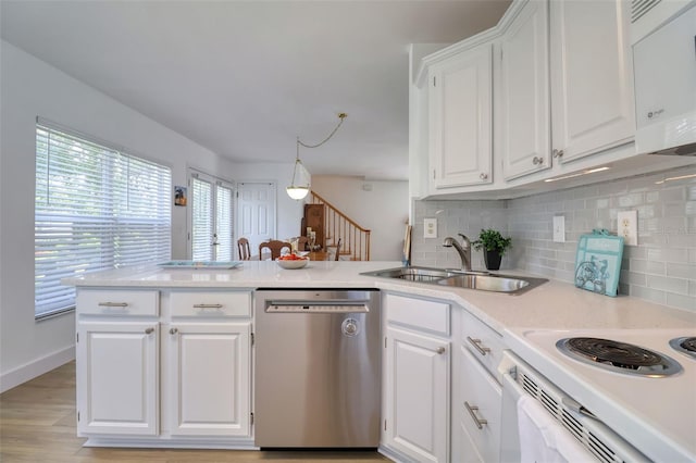 408 Georgia Ave, Crystal Beach, FL 34681 - kitchen featuring stainless steel dishwasher, a peninsula, backsplash, and white cabinets