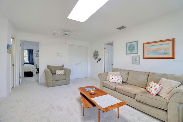 408 Georgia Ave, Crystal Beach, FL 34681 - living area featuring carpet flooring, a skylight, and a ceiling fan
