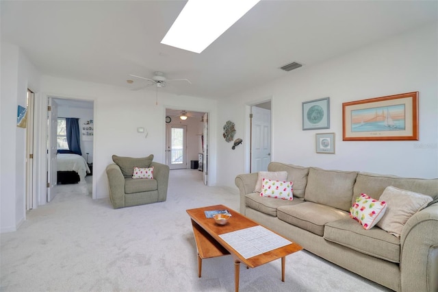 408 Georgia Ave, Crystal Beach, FL 34681 - living room featuring healthy amount of natural light, light colored carpet, ceiling fan, and a skylight