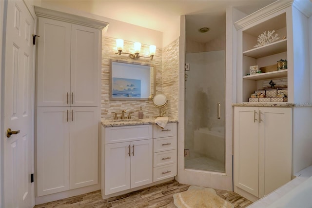 408 Georgia Ave, Crystal Beach, FL 34681 - bathroom with a shower stall, vanity, wood finished floors, backsplash, and a closet