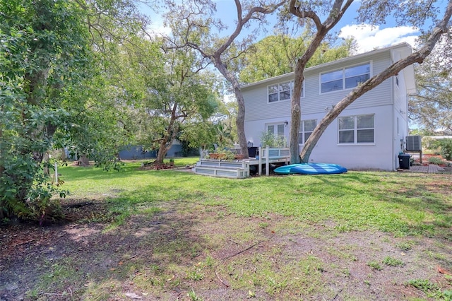 408 Georgia Ave, Crystal Beach, FL 34681 - back of house featuring a wooden deck and a lawn