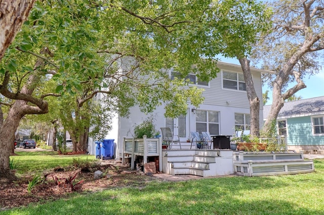 408 Georgia Ave, Crystal Beach, FL 34681 - rear view of property featuring a lawn and a wooden deck