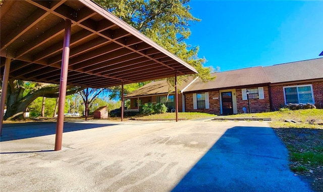 35140 Whispering Oaks Blvd, Dade City, FL 33523 - view of parking / parking lot featuring a storage unit and a detached carport